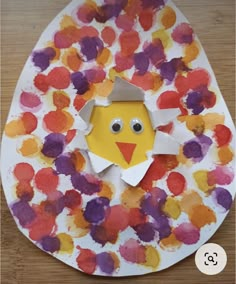 a paper plate with an egg shaped like a chick