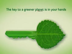 a key to a greener planet is in your hand with green leaves on it