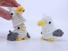 two small crocheted birds sitting next to each other