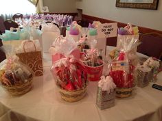 baskets filled with candy and candies are on a table at a banquet or party