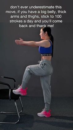 a woman is sitting on a chair and stretching her arms out to the side with one leg in the air