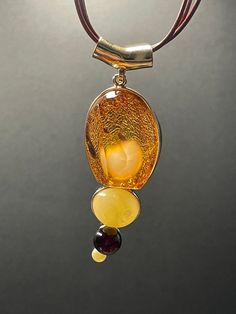 A ball of butterscotch amber looking like a fluffy rabbit tail wrapped inside a piece of 3A's super clear cognac amber formed this rare piece of jewel. The design is completed with two other butterscotch amber and one blood amber beads. Pendant height: 77.1 mm Pendant width: 26.4 mm Pendant thickness: 23.7 mm Necklace length: 450 mm with extender  Weight: 24.41 g ABOUT OUR PRODUCTS All our ambers are 100% natural, not in any way enhanced. Every item in our shop are handmade with love and happy v Luxury Amber Gold-plated Jewelry, Luxury Citrine Amber Necklace, Luxury Amber Necklaces With Gemstone Accents, Luxury Amber Citrine Necklace, Luxury Carnelian Amber Necklace, Luxury Amber Necklaces Fine Jewelry, Luxury Amber Oval Necklaces, Cheap Amber Necklaces, Luxury Amber Necklace For Formal Occasions