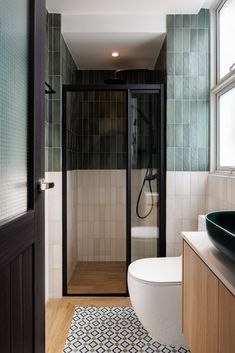 a bathroom with a shower, toilet and sink