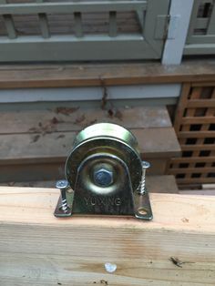 a metal object sitting on top of a piece of wood