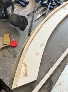 the surfboard is being worked on with tools