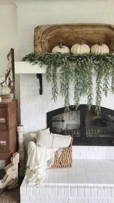 a living room filled with furniture and a fire place covered in greenery next to a fireplace