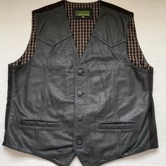 "Mens Black Leather Waistcoat- Motorcycle Biker Casual Sleeveless Vest  Quality grade soft hide leather Black Cotton Back with Checked Brown Black Cotton Lining 2 x Front Pockets & 2 x Inside Pockets (trimmed with leather) 4 x Front Button Fastening - Adjustable strap with metal rings at back Excellent clean vintage condition - minimal wear Hide Park (Top Grade Hide) Label SIZE 3XL - Check the Measurements-Chest:  54\"/56\" (armpit to armpit 26\" /67cm across when laid flat) Length:  29\" /74cm Black Leather Biker Vest, Sleeveless Leather Vest For Bikers, Black Sleeveless Motorcycle Vest, Black Sleeveless Motorcycling Vest, Black Leather Vest Vintage, Leather Waistcoat, Biker Vest, Vintage Biker, Mens Black Leather