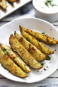 a white plate topped with grilled potatoes on top of a wooden table next to an instagram post