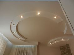 the ceiling in this living room is made of white plaster and features recessed lighting