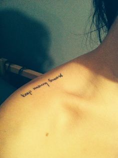 the back of a woman's shoulder with an inscription on it