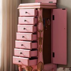 a pink dresser with many drawers in it