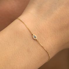 Lucille Embrace timeless protection and understated sparkle with the Minimalistic Design Diamond Sapphire Evil Eye Cutout Bracelet. This exquisite bracelet features a dainty14k solid gold chain (available in yellow, white, or rose gold) adorned with a unique evil eye cutout design. Sparkling diamonds line the edge of the eye, while a vibrant sapphire takes center stage. - Handmade- Natural Diamonds and Sapphire - G Color, SI Quality Diamonds- Total Diamond Carat Weight: 0.04 ctw- Total Sapphire Carat Weight: 0.03 ctw- Dimensions of Evil Eye: 4.5 x 8.5 mm All pieces come beautifully boxed in suede pouches you can always use when traveling! Bracelets Gold Diamond Unique, Evil Eye Gold Bracelet, Evil Eye Jewelry Bracelet, Evil Eye Bracelet Gold, Delicate Gold Bracelet, Gold Rings Fashion, Solid Gold Chains, Rings Fashion, Bracelets Gold Diamond