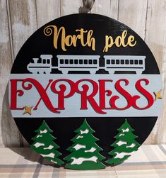 a sign that says north pole express with trees on the front and train on the back