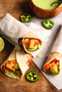 two burritos with chicken, peppers and jalapenos cut in half