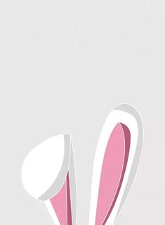 an easter bunny's ears sticking out of the side of a white vase with pink flowers in it