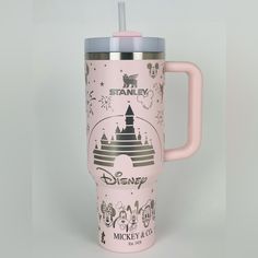 a pink disney travel mug with an insulated lid