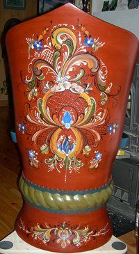 an ornately painted vase sitting on top of a wooden table