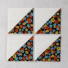 four pieces of paper with flowers on them are arranged in the shape of triangles