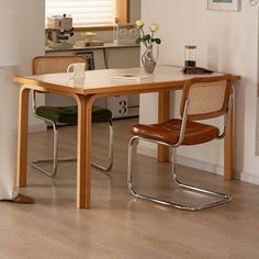 a kitchen table with two chairs next to it