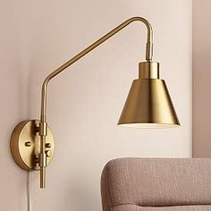 a gold wall light next to a couch