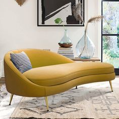 a blue chaise lounge chair sitting on top of a rug in a living room