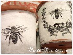 two potted planters with painted bees on them, one is brown and the other is white