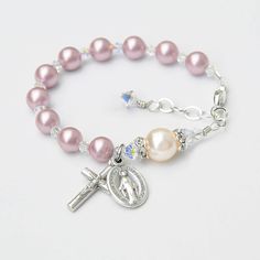 Please let me know the date of the event along with personalization details, if applicable, in the notes box at checkout. ¸.**'¨) (¸.*'✻ Made with genuine Swarovski crystals and pearls. No seed beads. (¸.*'✻ For the matching set with rosary, please click here: https://www.etsy.com/listing/545875789/ Celebrate the Baptism of a baby girl with this beautiful dusty rose pink and cream pearl rosary bracelet. The bracelet features genuine Swarovski crystals and crystal pearls throughout. The Our Fathe Elegant Beaded Rosary Bracelet For First Communion, Pink Beaded Jewelry For First Communion, Adjustable Pearl Bracelet With Round Beads For First Communion, Baby Girl Baptism Gift, Pearl Rosary, Dusty Rose Pink, Rosary Bracelet, Baptism Girl