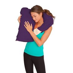 a woman holding a pillow on her back