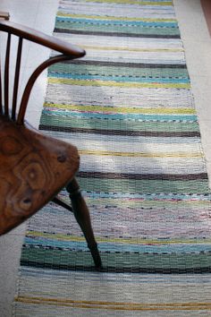 a wooden chair sitting on top of a rug