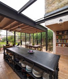 an outdoor kitchen with lots of plates and bowls on the counter