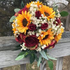 a bridal bouquet with sunflowers, roses and baby's breath