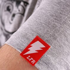 a man's arm with a red and white lightning sticker on the wrist