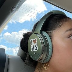 a woman wearing headphones with the words i love hs on it's ear