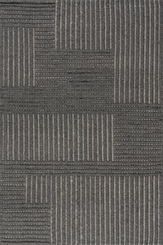 an area rug with grey and white stripes on it, in the shape of squares