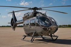 a helicopter sitting on top of an airport tarmac