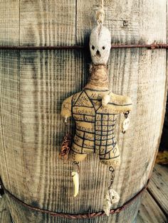 an old wooden barrel with a toy soldier hanging from it's side on a chain