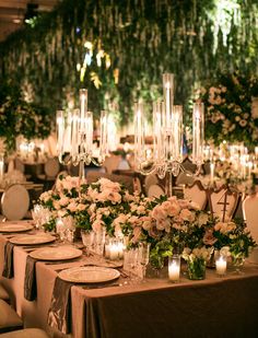 the tables are set with candles and flowers