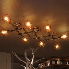 the lights are hanging from the ceiling above the bookshelves in the library area