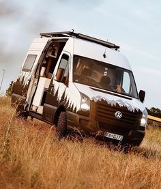 a van parked in the middle of a field