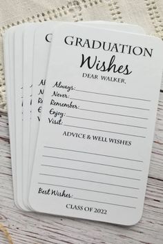 three graduation wishes cards sitting on top of a table