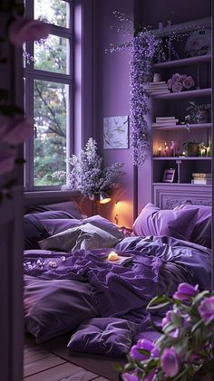 a bed with purple sheets and pillows next to a book shelf filled with books, candles and flowers