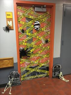 a door decorated with yellow caution tape and skeletons