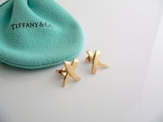 Everyone needs a signature Tiffany piece! Here is the perfect one just for you. Offered for sale is a wonderful and just fabulous Tiffany & Co. Picasso 18K Gold Medium "X" / Kiss earrings. The earrings are crafted from bright and substantial Tiffany Gold formed into a classic and super elegant Kiss / X shape - unique, elegant and yet very feminine piece! It is a wonderful pair that fits a lifestyle on the go -- they can be worn to almost any occasion! The earrings are simple, elegant, and cl Kiss Earrings, Tiffany And Co Earrings, Tiffany Gold, Rare Gifts, Earrings Studs, Tiffany And Co, Gift Pouch, Simple Elegant, Weekend Wear