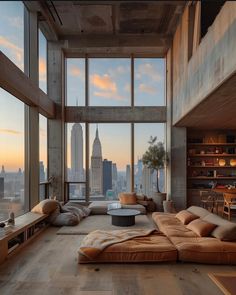 a living room filled with lots of furniture and large windows overlooking the cityscape