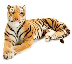 a stuffed tiger laying down on the ground