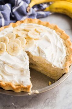 a banana cream pie with one slice cut out