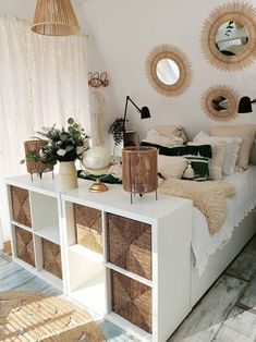 a bedroom with wicker baskets on the bed and round mirrors hanging from the ceiling