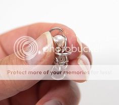 a person holding a tiny keychain in their hand