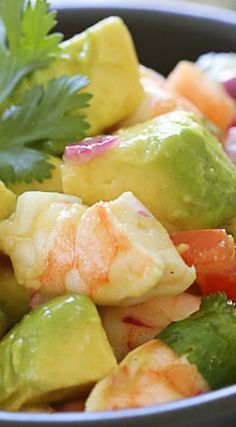 a salad with shrimp, avocado and cilantro