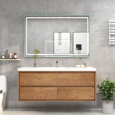 a bathroom with a sink, mirror and toilet in it's centerpieces